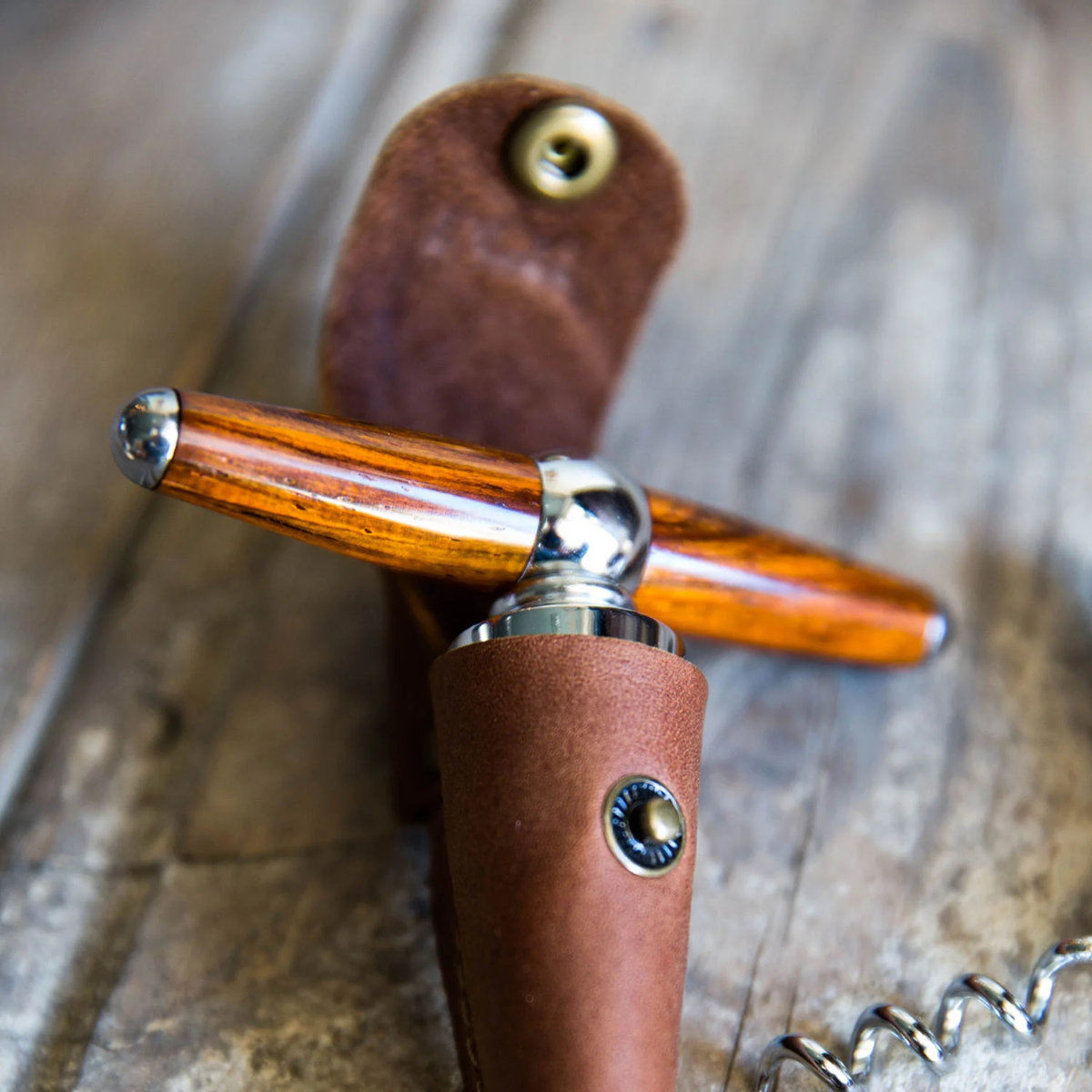39. Toast to Three Years of Love with a Unique Leather Wine Bottle Stopper